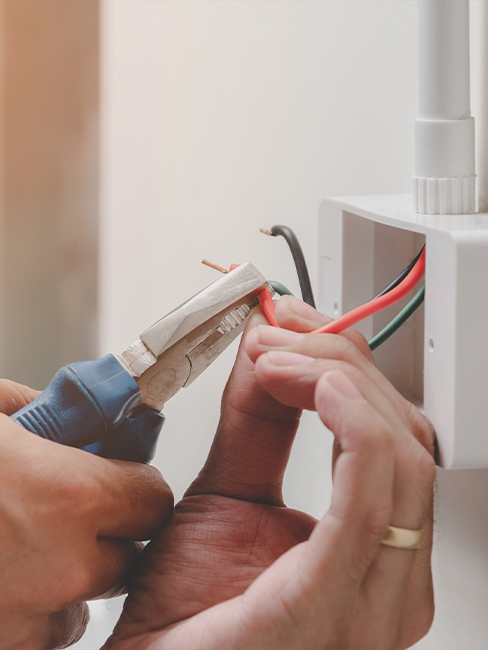 Electrician working on electrical panel at KA Talarico Electric LLC office.