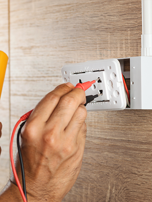 Electrician installing electrical wiring for residential or commercial building powered by KA Talarico Electric.