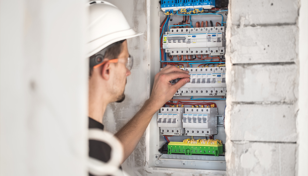 Electricians working on electrical system, emphasizing trust and safety in KA Talarico Electric LLC's services.